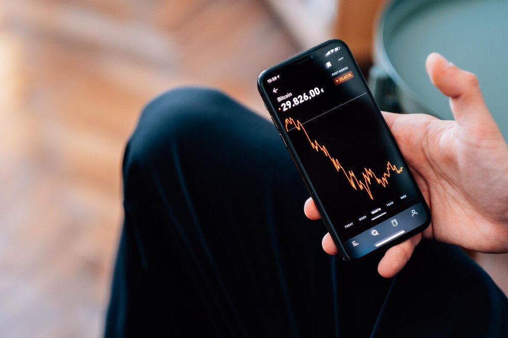 selective-focus-shot-male-hand-holding-smartphone-with-cryptocurrencies-statistics-screen_181624-59051.jpg